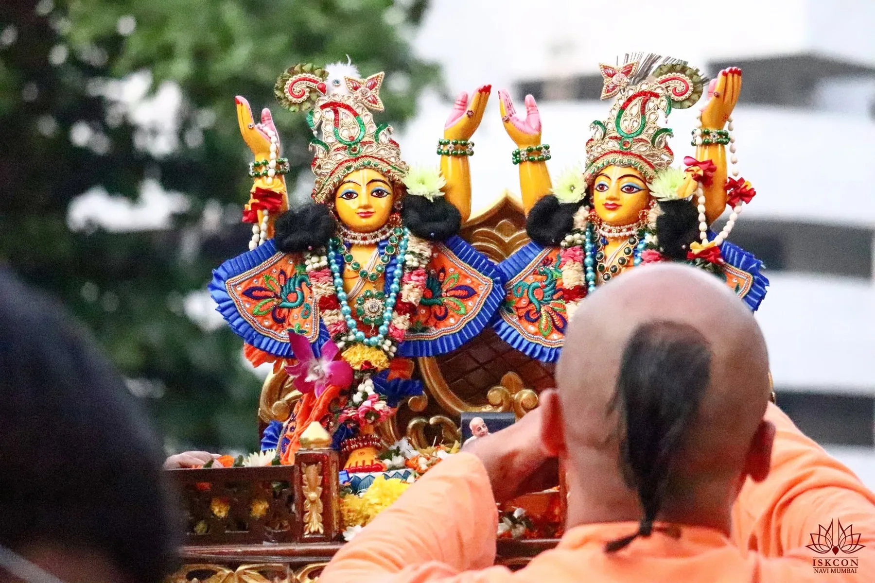 Sri Sri Gaura-Nitai on Their palanquin, arms raised in the kirtan