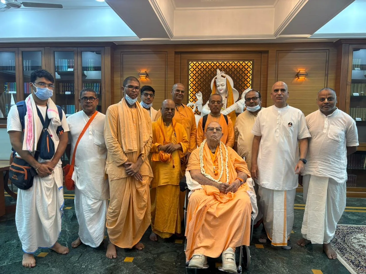 Sannyasis and devotees in the temple library, before Saraswati Devi